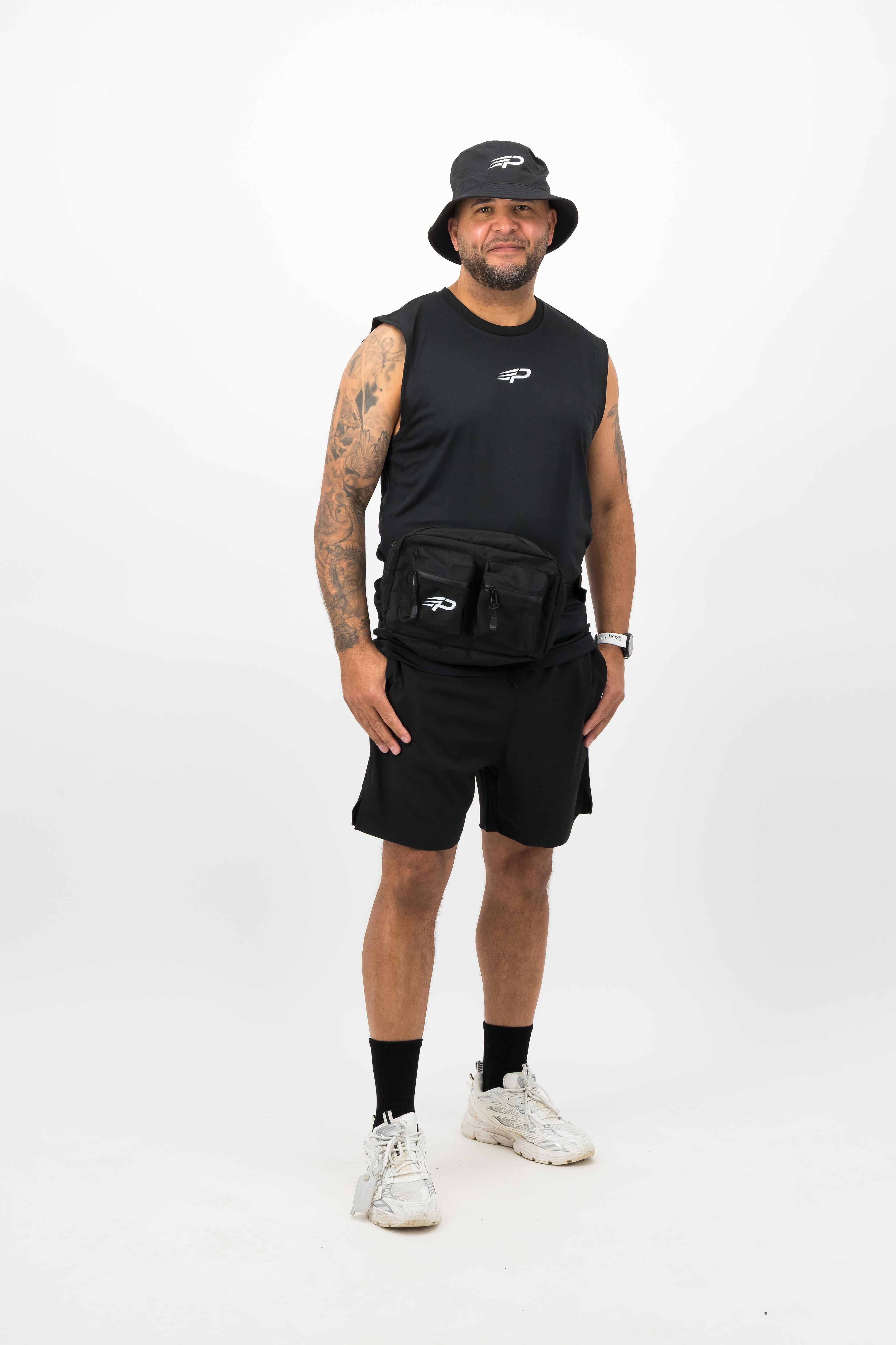 Person wearing a Concept Padel black bucket hat with a black sleeveless top and black shorts standing facing forward against a white background