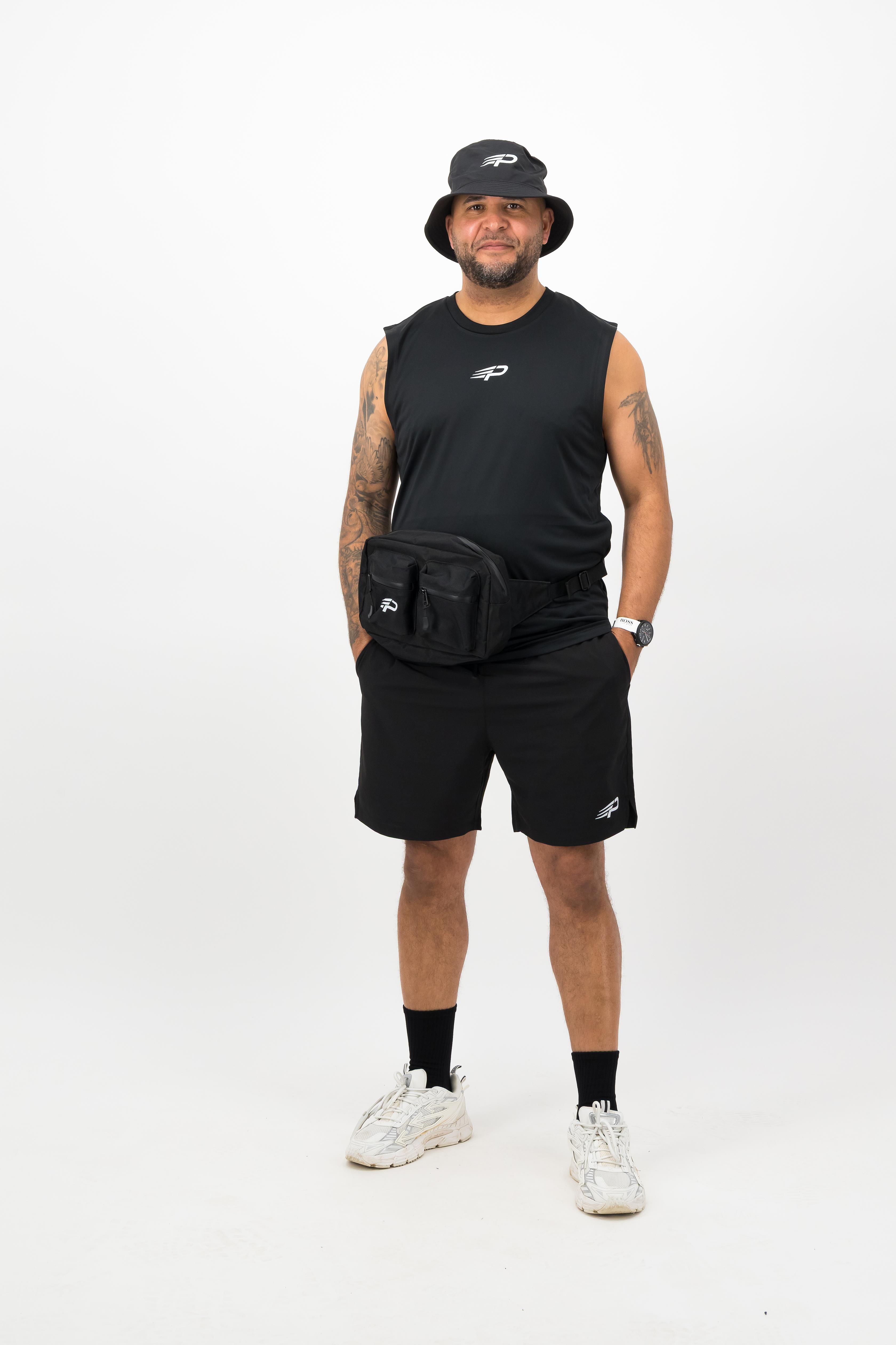 Person wearing a Concept Padel black bucket hat with a black sleeveless top and black shorts standing facing forward against a white background