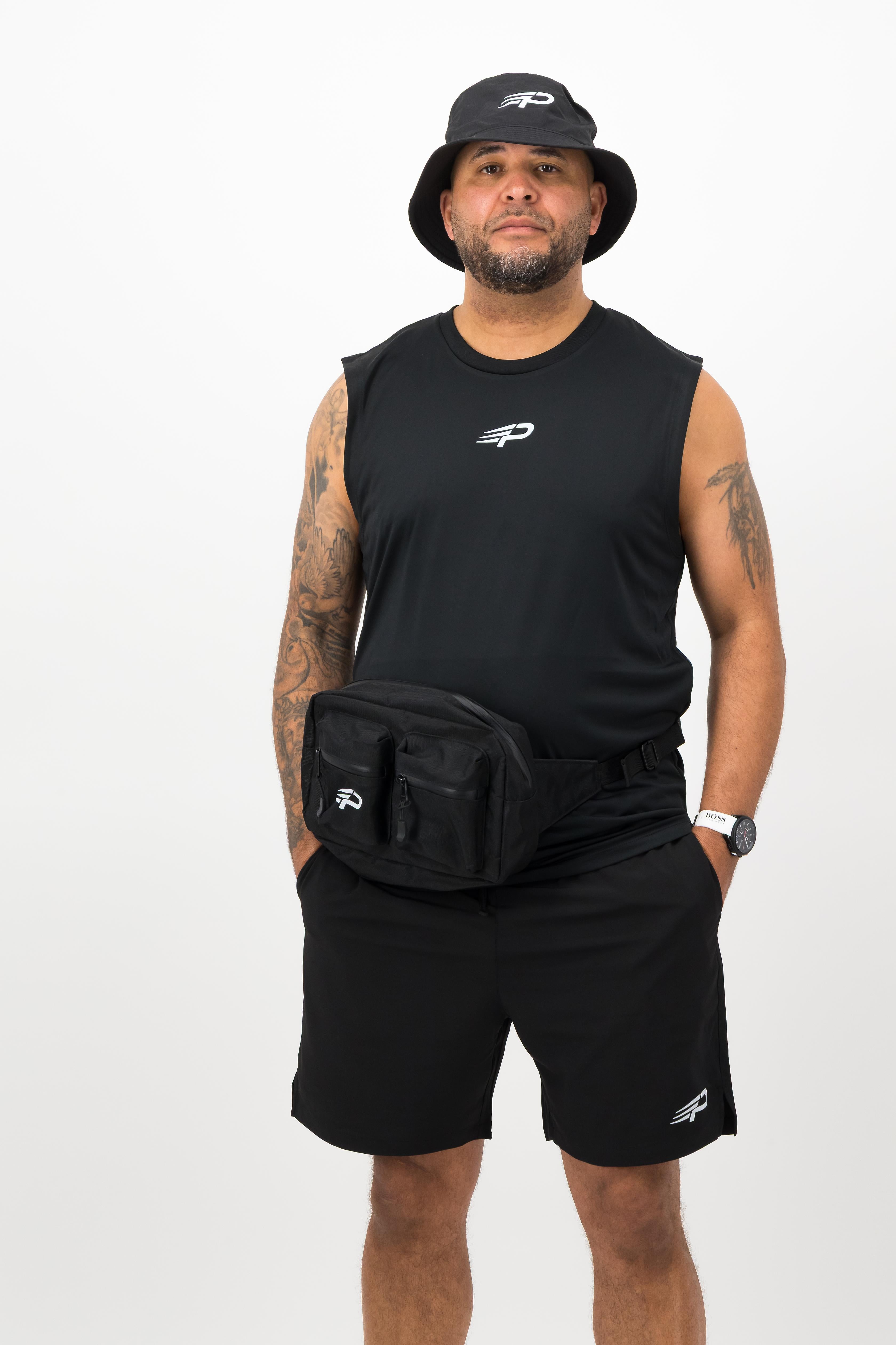 Man wearing black Concept Padel body belt bag with sleeveless top, shorts and bucket hat