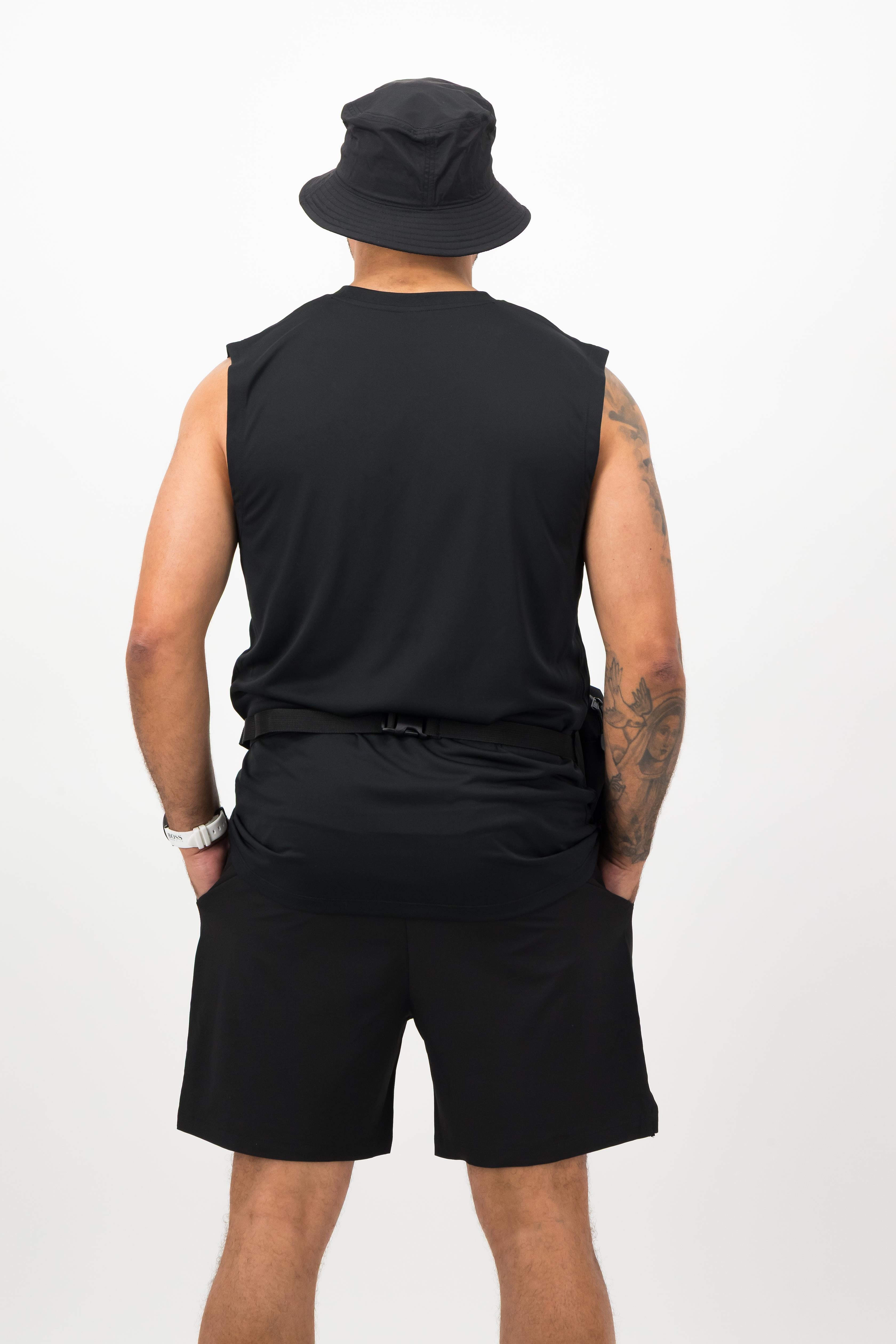Back view of man wearing black Concept Padel body belt bag with athletic outfit