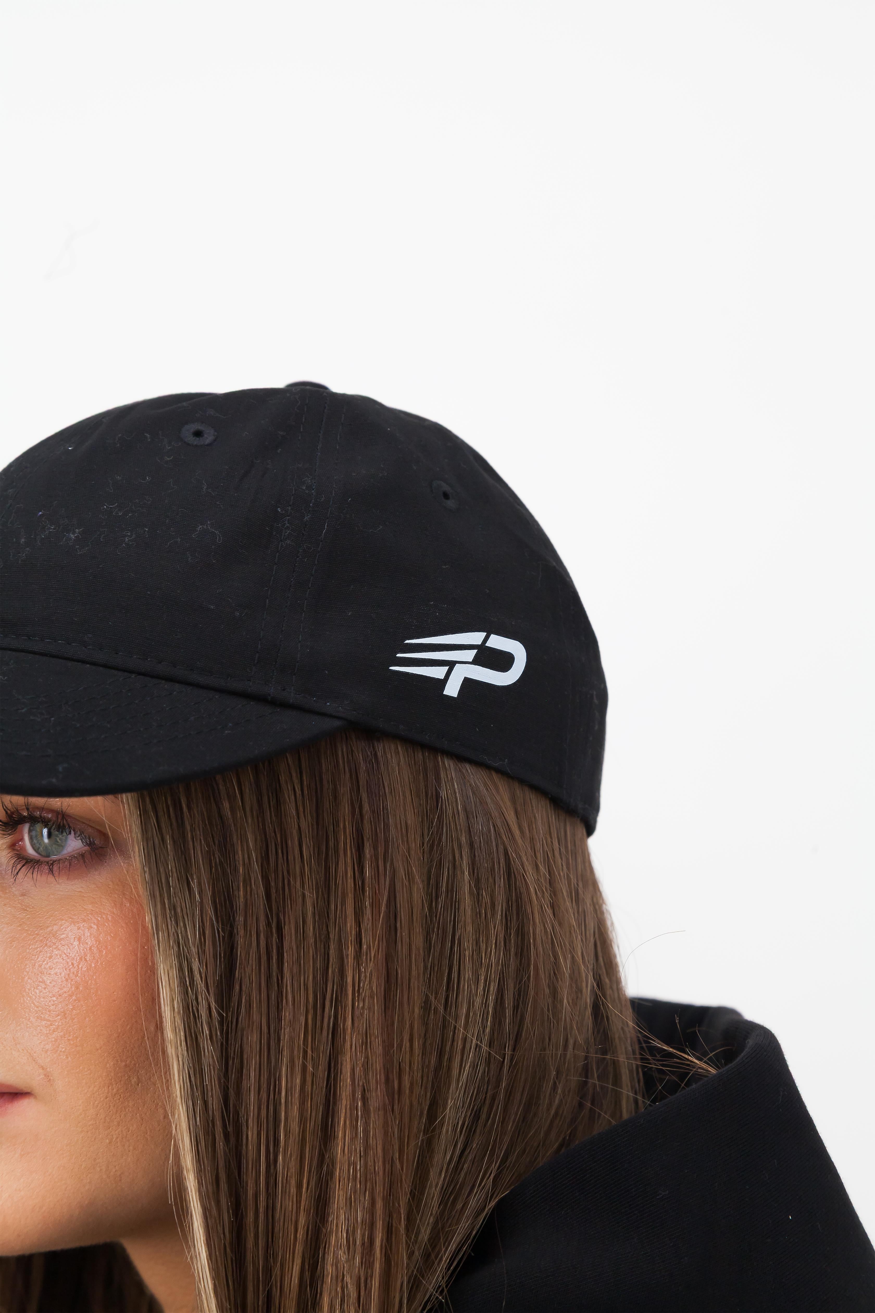 Close up of black Concept Padel cap with white embroidered logo