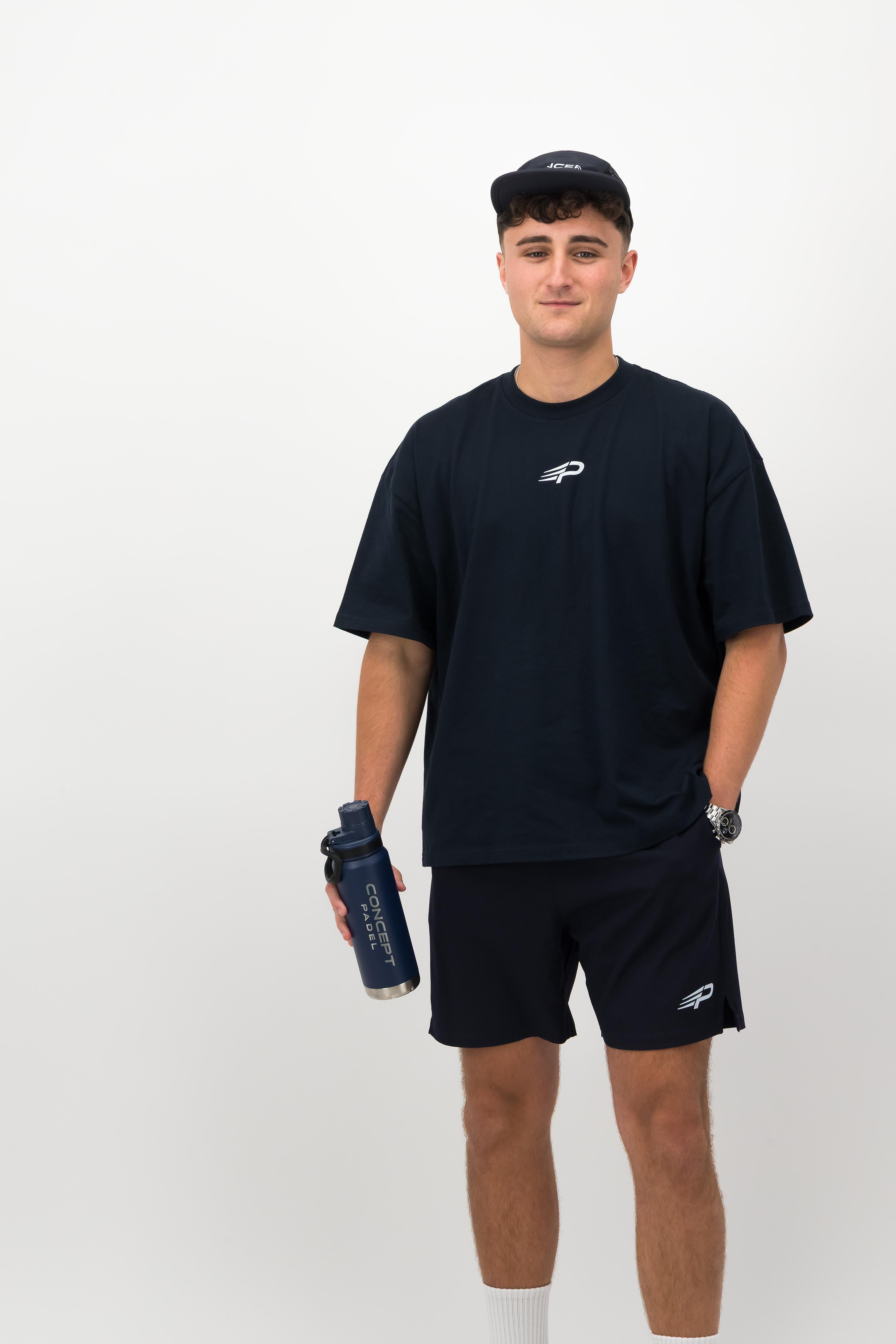 Man wearing navy Concept Padel performance cap front view