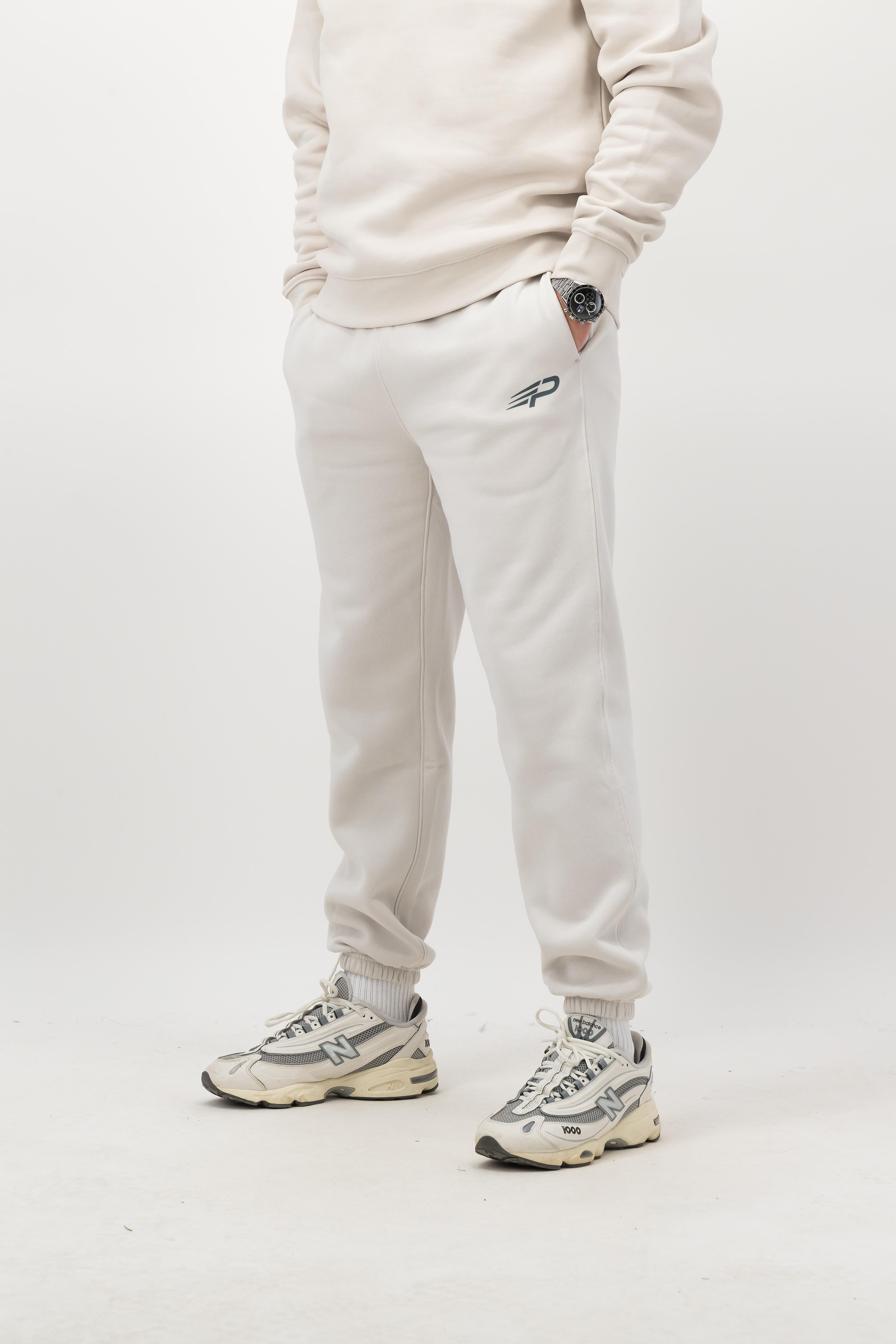 Person wearing Concept Padel bone rebound sweatpants standing facing forward, styled with matching sweatshirt and trainers against a white background