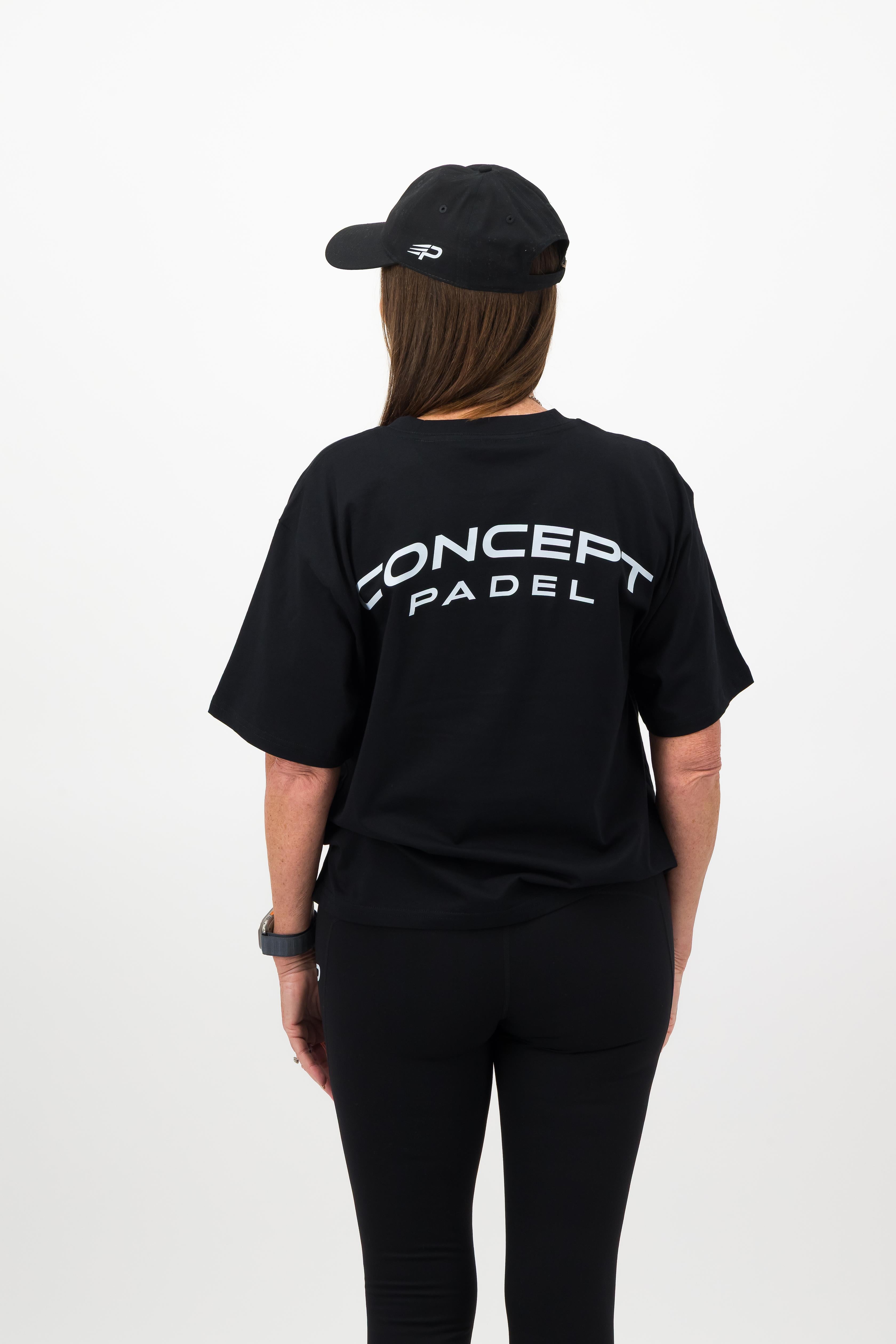 Side view of woman wearing black Concept Padel cap
