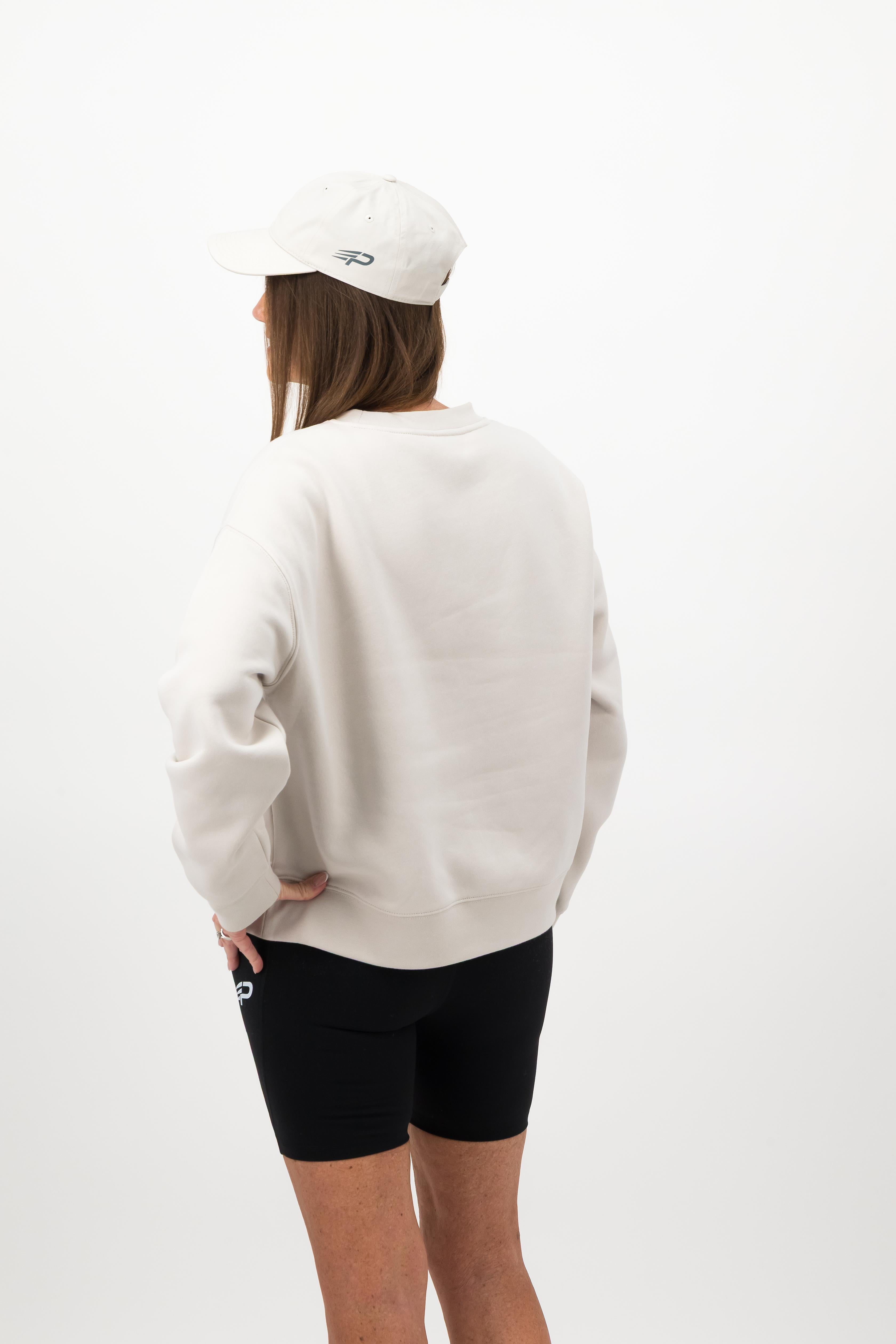 Side view of woman wearing bone Concept Padel cap