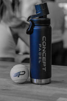 Blue Concept Padel water bottle with a paddle ball on a wooden surface