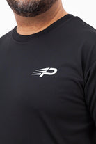 Close‑up of the Concept Padel logo on the black performance tee worn against a white background