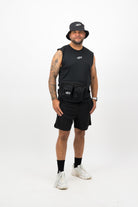 Person wearing a Concept Padel black bucket hat with a black sleeveless top and black shorts standing facing forward against a white background