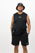 Man wearing black Concept Padel body belt bag with sleeveless top, shorts and bucket hat