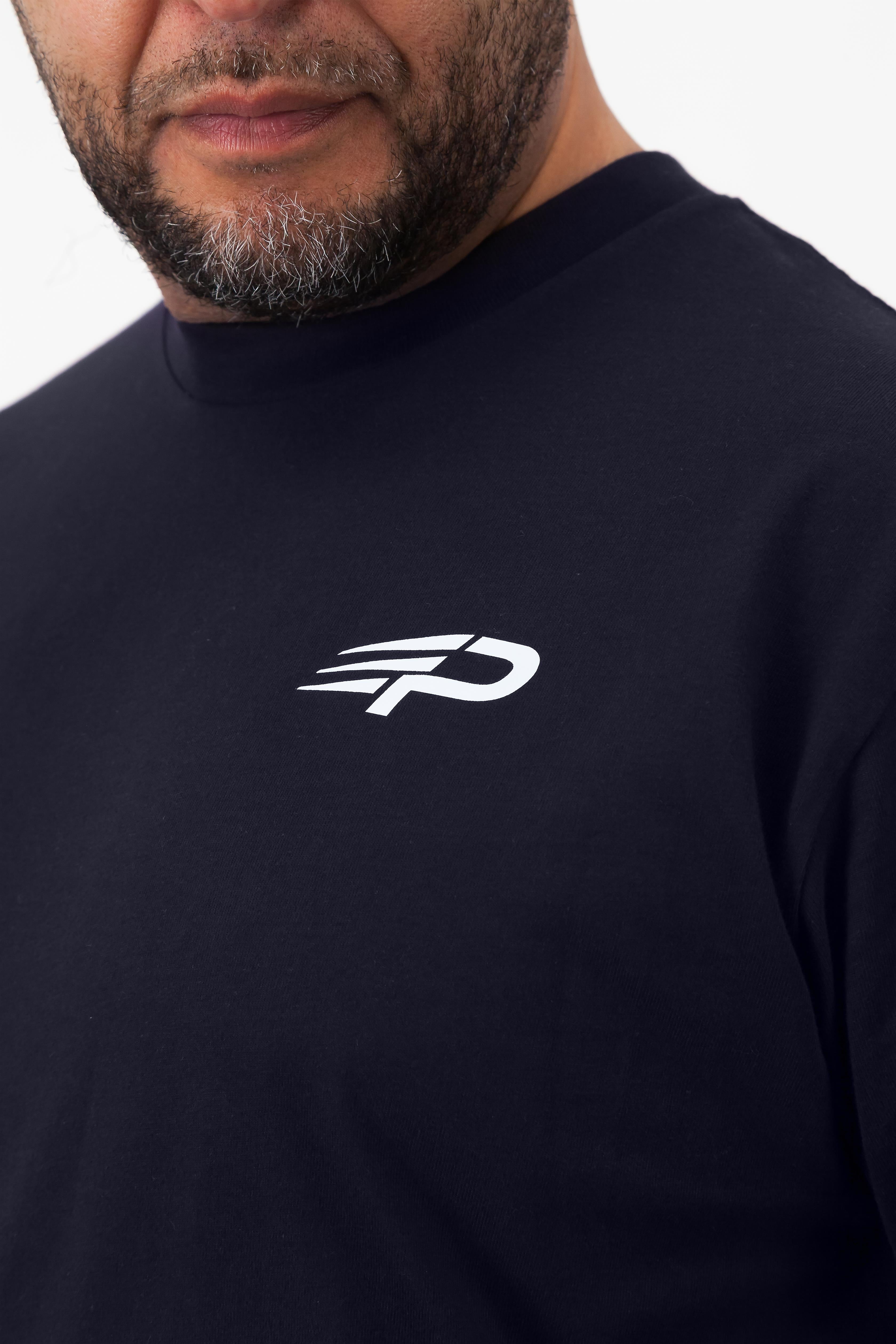 Close‑up of the Concept Padel logo on the ink blue rebound tee worn against a white background