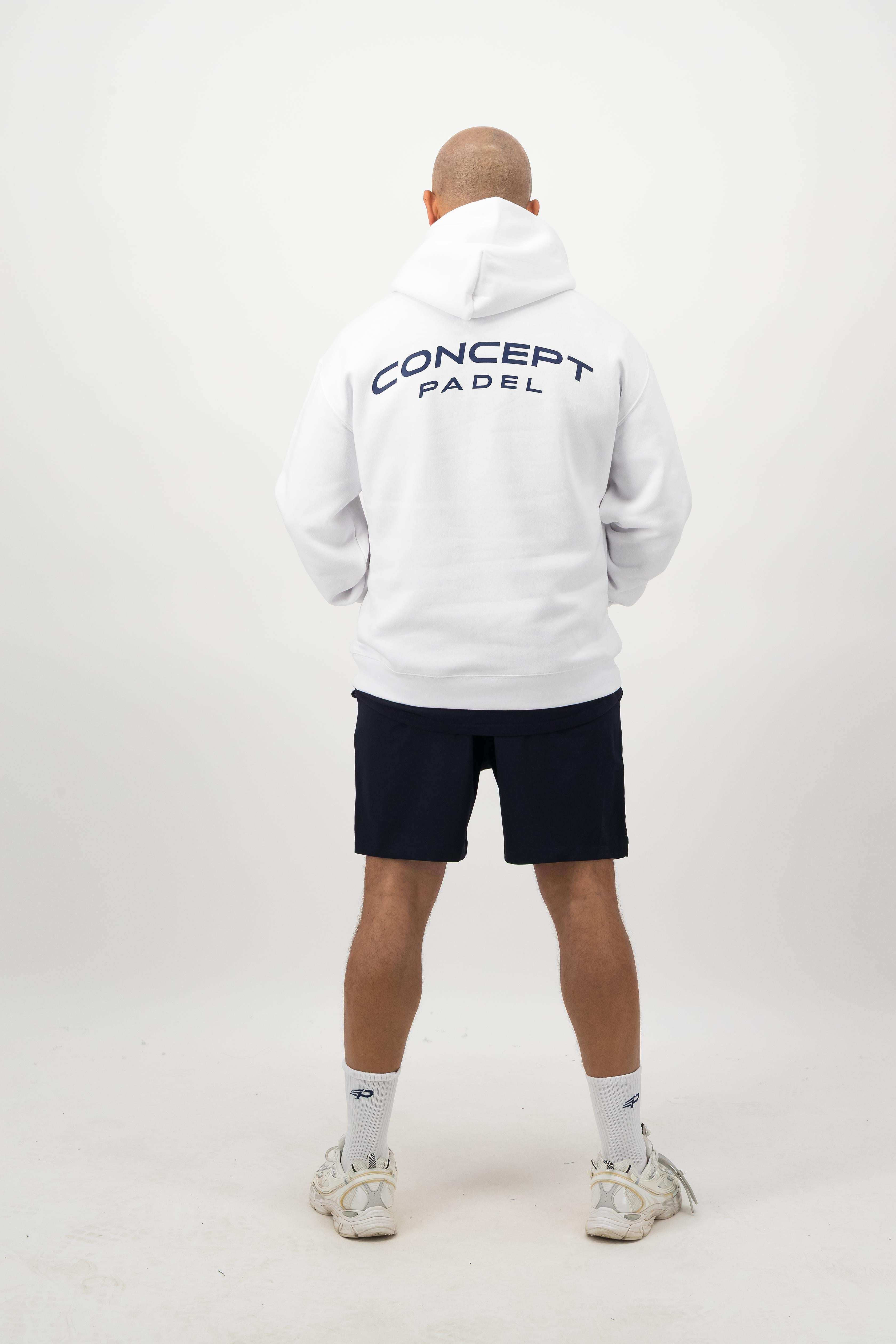 Person wearing a Concept Padel white rebound hoodie standing with back to camera showing the back graphic, styled with black shorts and trainers against a white background