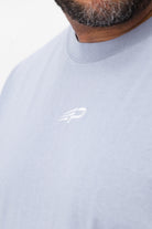 Close‑up of the Concept Padel logo on the powder faded tee worn against a white background