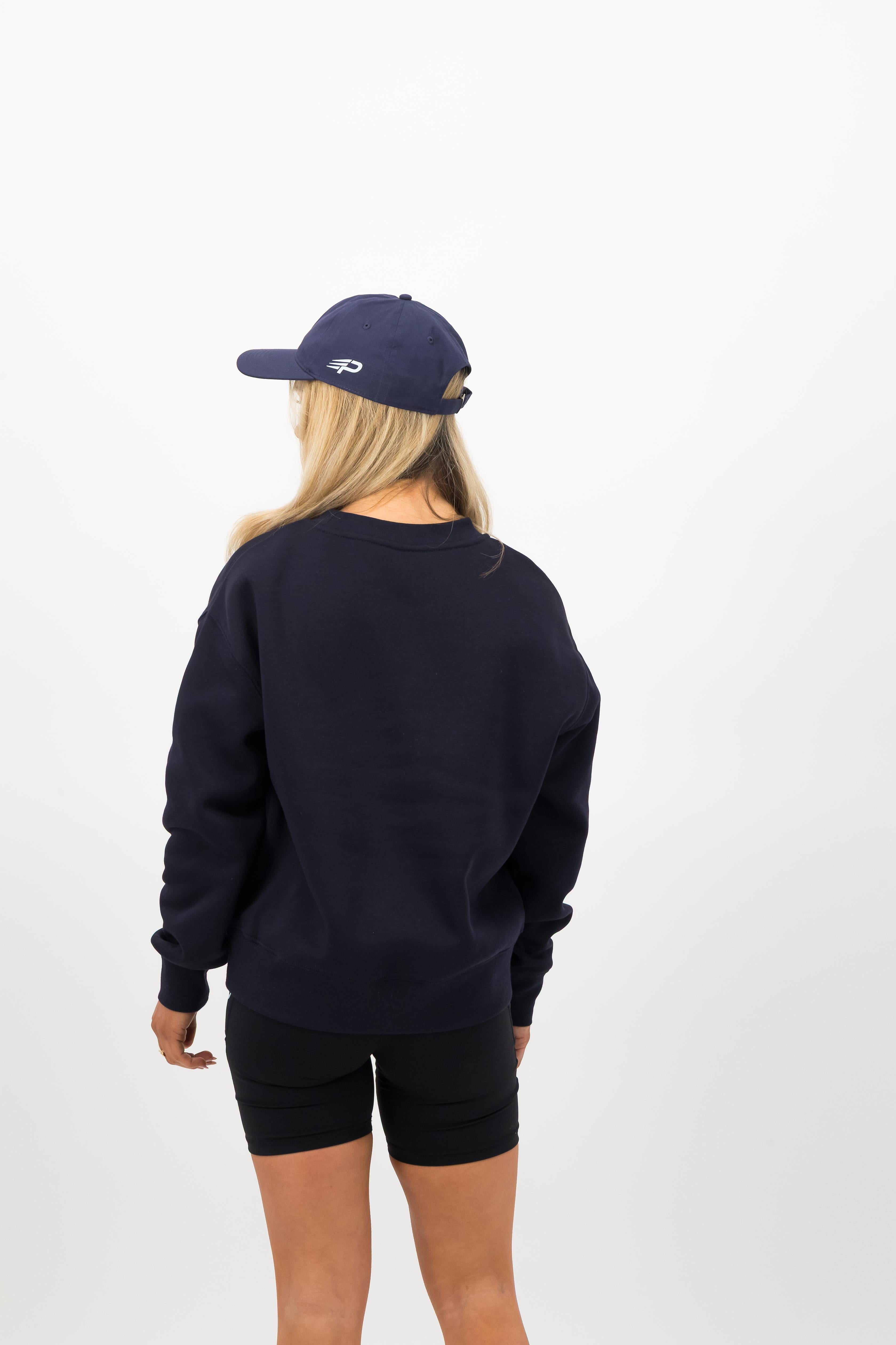 Full outfit featuring midnight blue Concept Padel cap, blue sweatshirt and black shorts