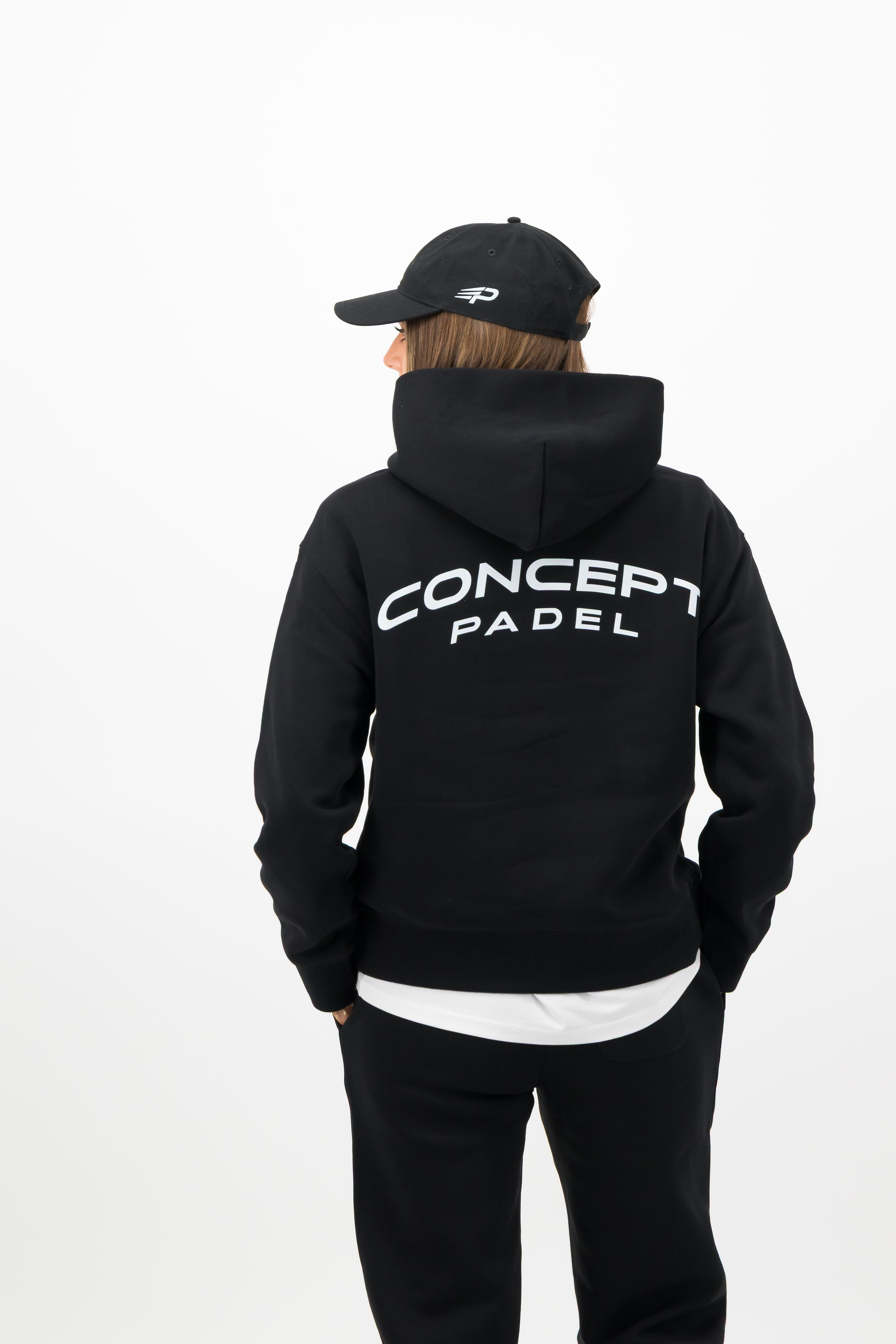 Woman wearing black Concept Padel cap with Concept Padel back print sweatshirt