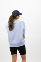 Back view of model wearing midnight blue Concept Padel cap with cycling shorts