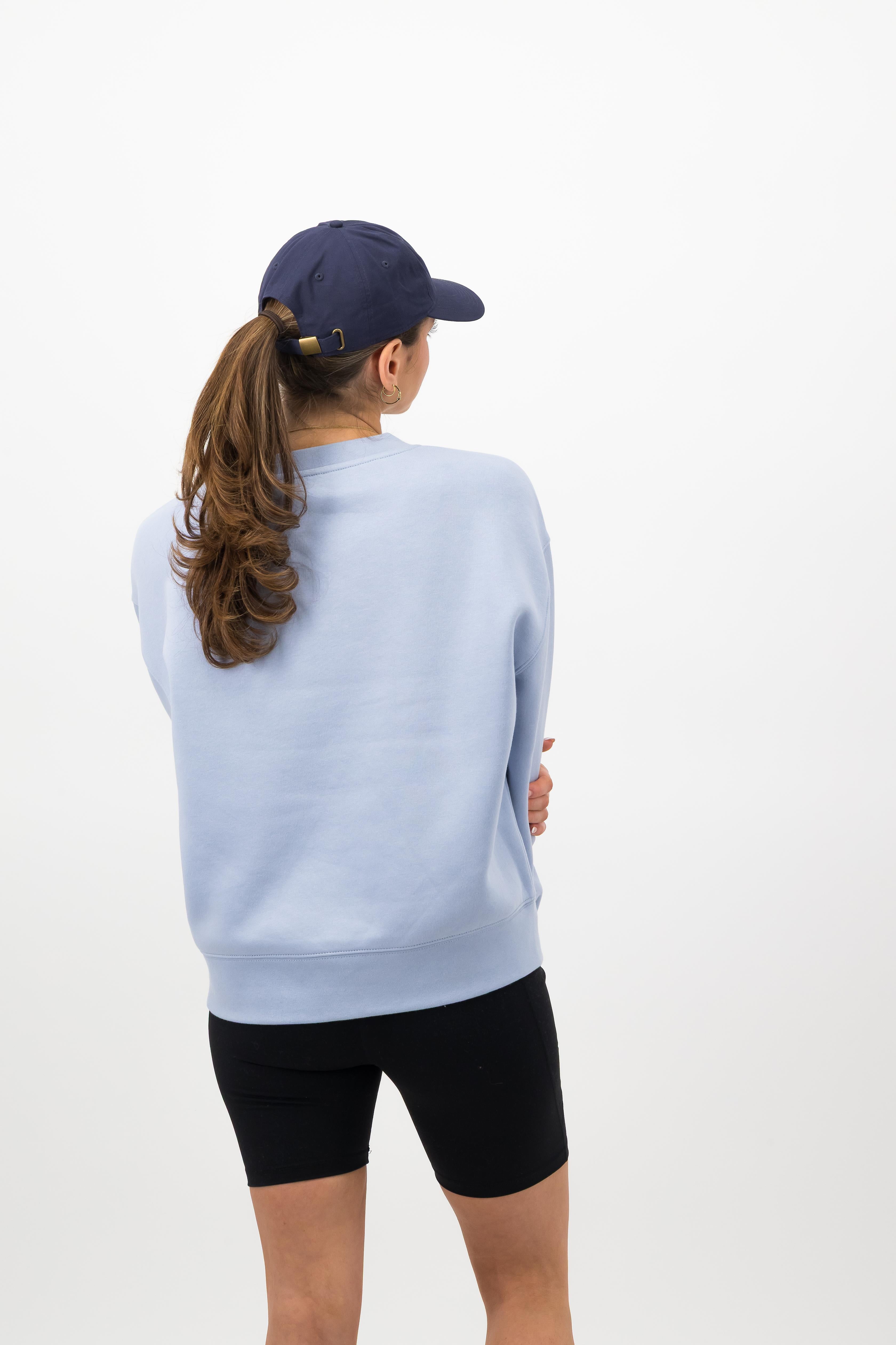 Back view of model wearing midnight blue Concept Padel cap with cycling shorts