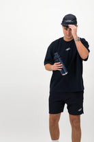 Man wearing navy Concept Padel performance cap holding padel racket