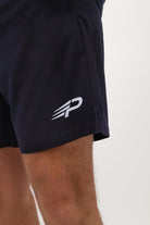 Close‑up of the Concept Padel logo on the ink blue performance shorts worn against a white background