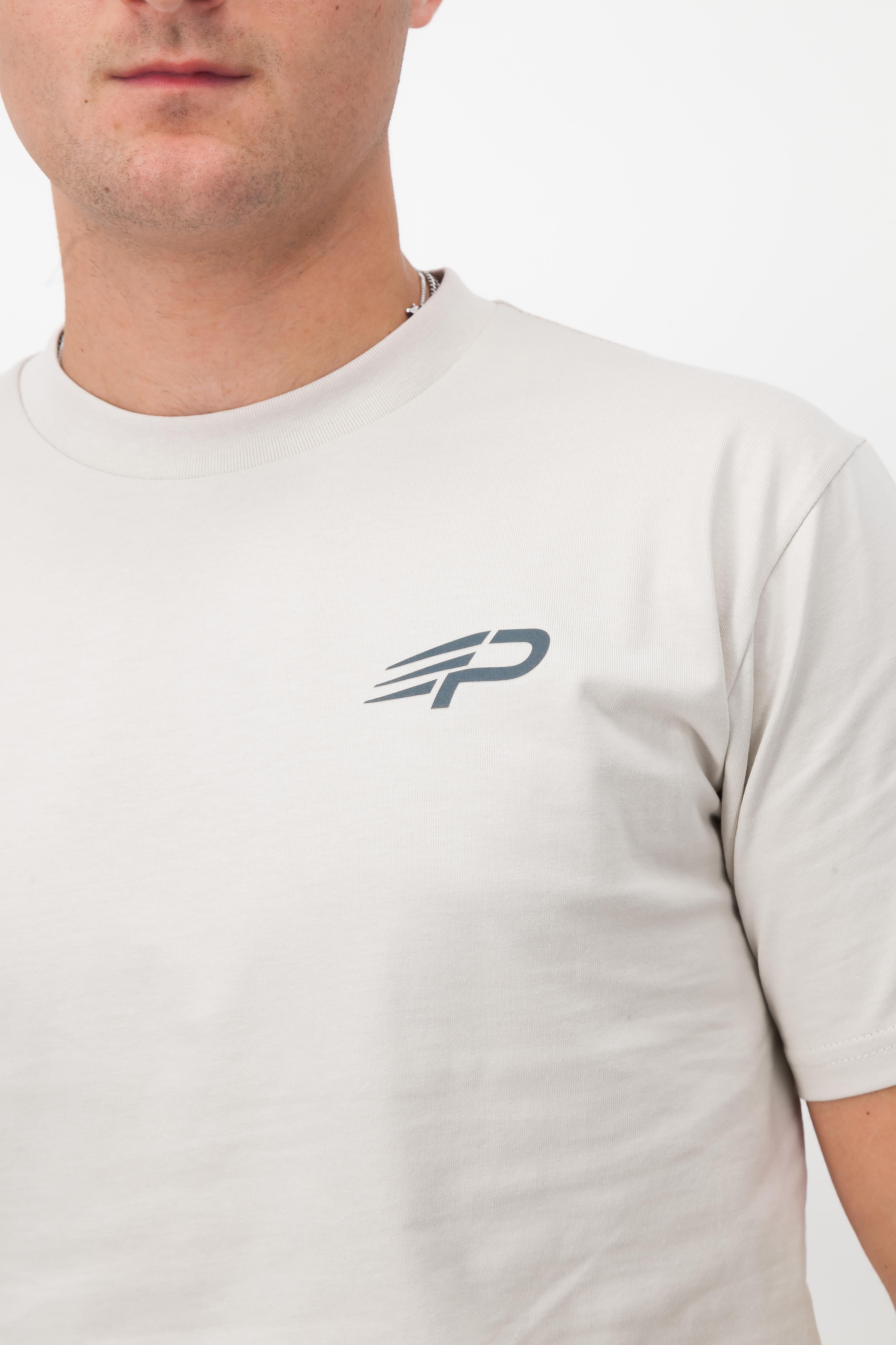 Close‑up of the Concept Padel logo on the bone rebound tee worn against a white background