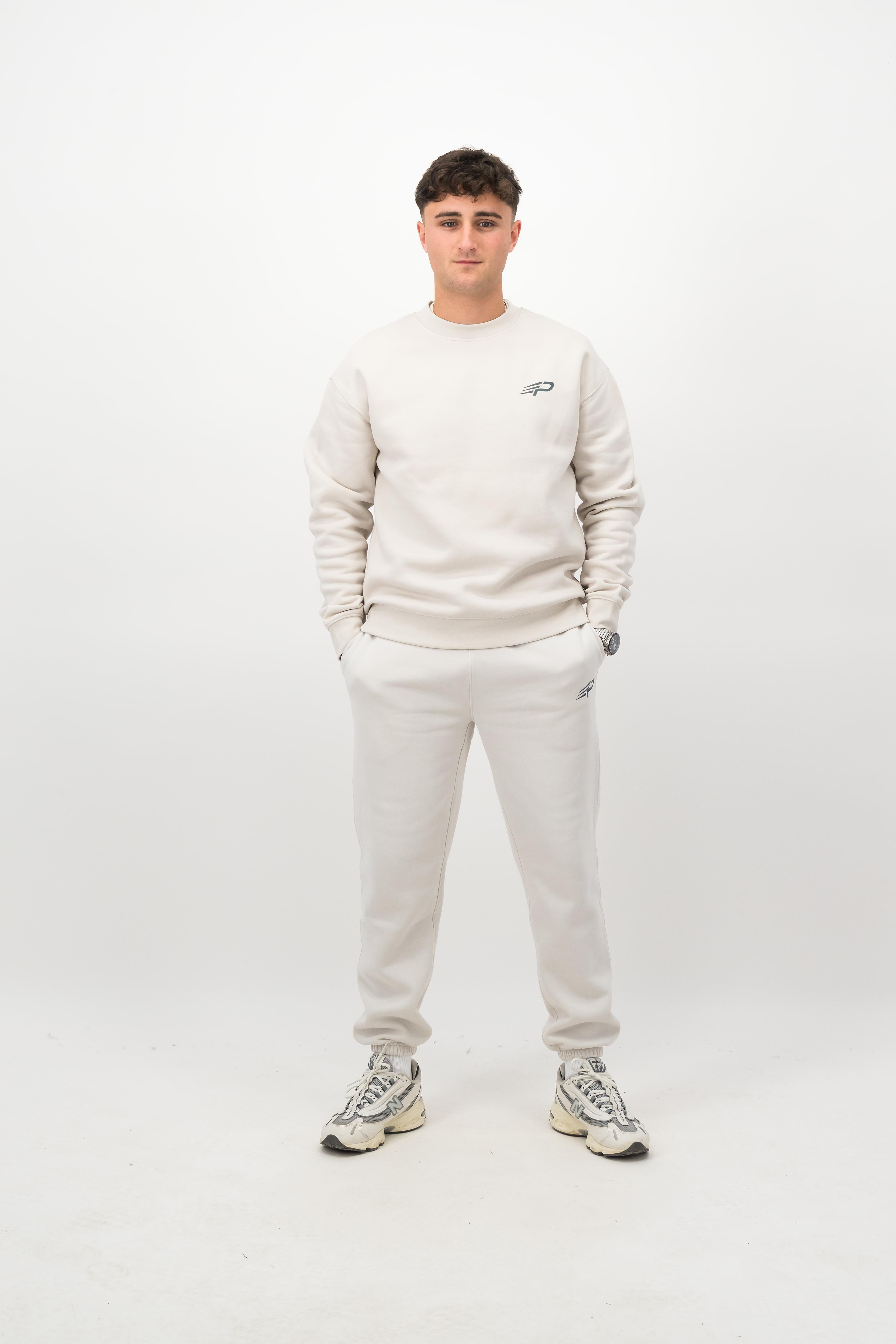 Person wearing Concept Padel bone rebound sweatpants standing facing forward, styled with matching sweatshirt and trainers against a white background