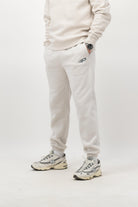 Person wearing Concept Padel bone rebound sweatpants standing facing forward, styled with matching sweatshirt and trainers against a white background