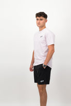 Person wearing a Concept Padel orchid rebound tee standing side on, paired with black shorts and trainers against a white background