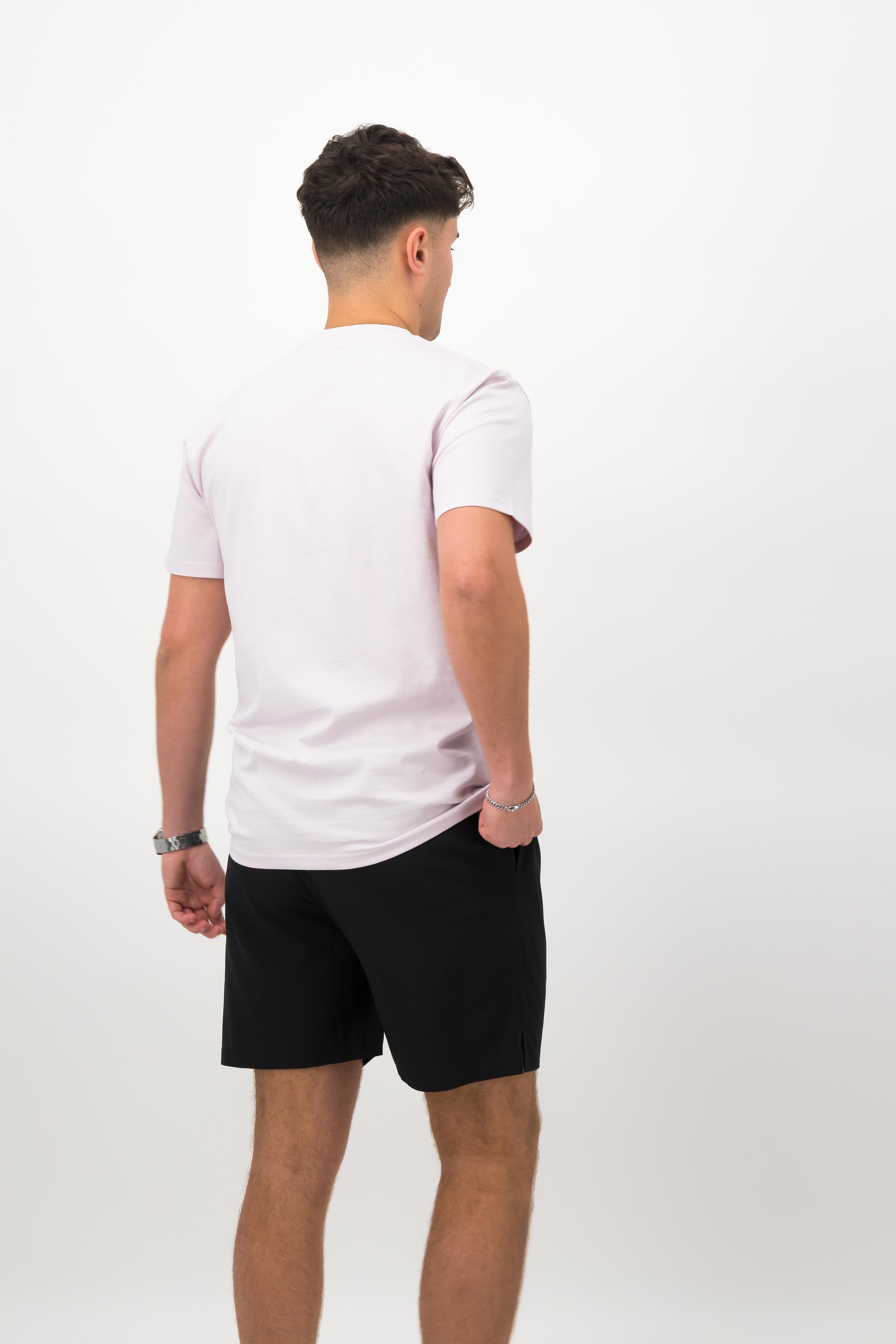 Person wearing a Concept Padel orchid rebound tee standing with back to camera showing the clean back silhouette, styled with black shorts and trainers against a white background