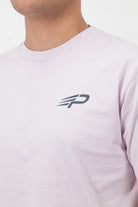 Close‑up of the Concept Padel logo on the orchid rebound tee worn against a white background