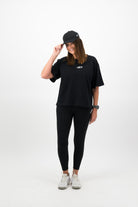 Woman wearing black Concept Padel cap with full black outfit
