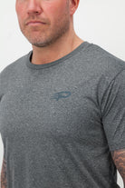 Close‑up of the Concept Padel logo on the graphite performance tee worn against a white background