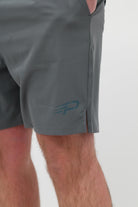 Close‑up of the Concept Padel logo on the shadow performance shorts worn against a white background
