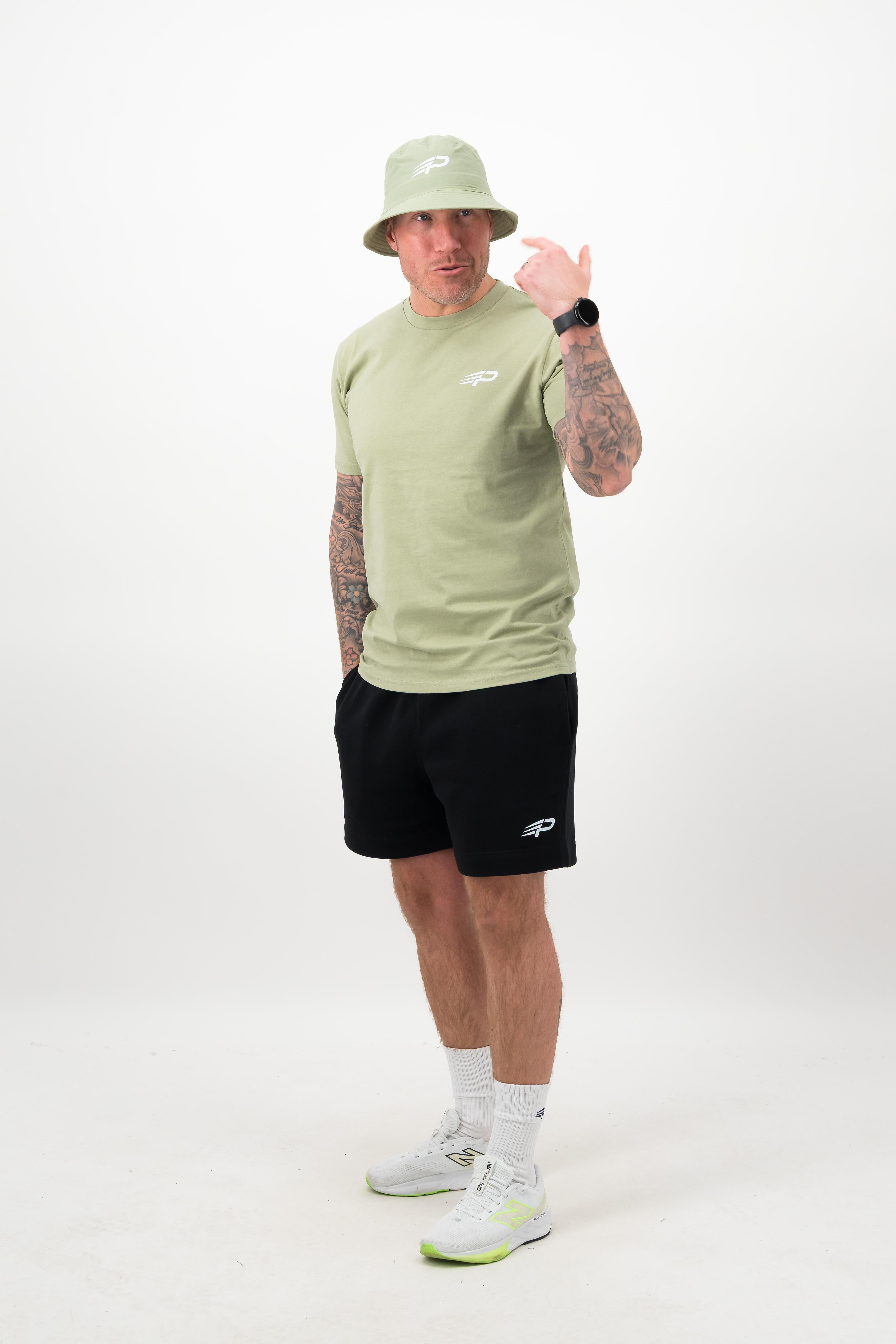 Side view of man wearing pistachio Concept Padel bucket hat