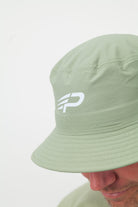 Close up of pistachio Concept Padel bucket hat with white logo