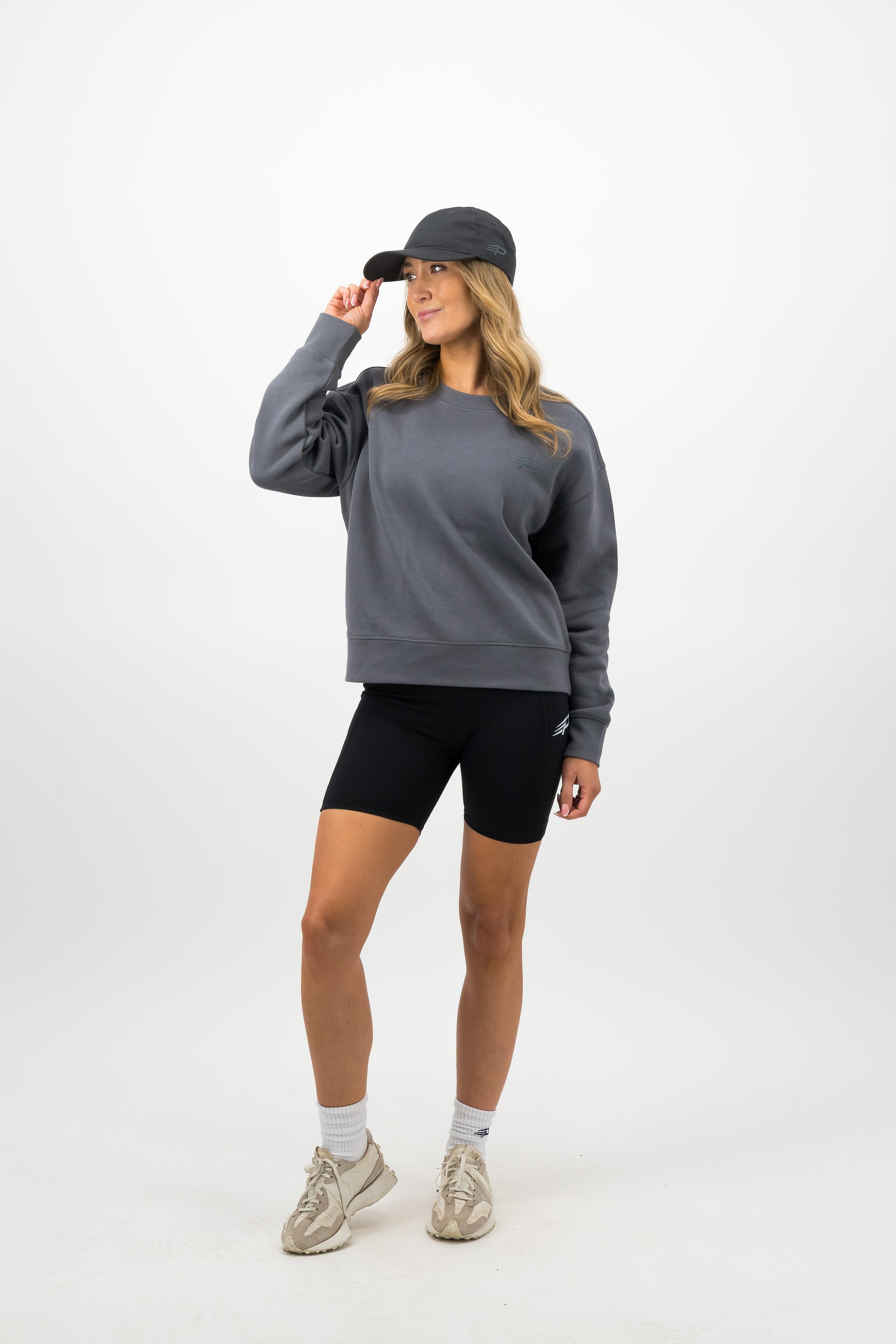 Woman wearing coal Concept Padel cap front view