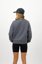 Side view of woman wearing coal Concept Padel cap