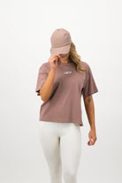 Woman wearing hazy pink Concept Padel cap with matching tee