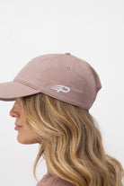 Woman wearing hazy pink Concept Padel cap
