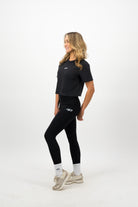 Woman wearing white Concept Padel socks styled with black leggings and beige trainers